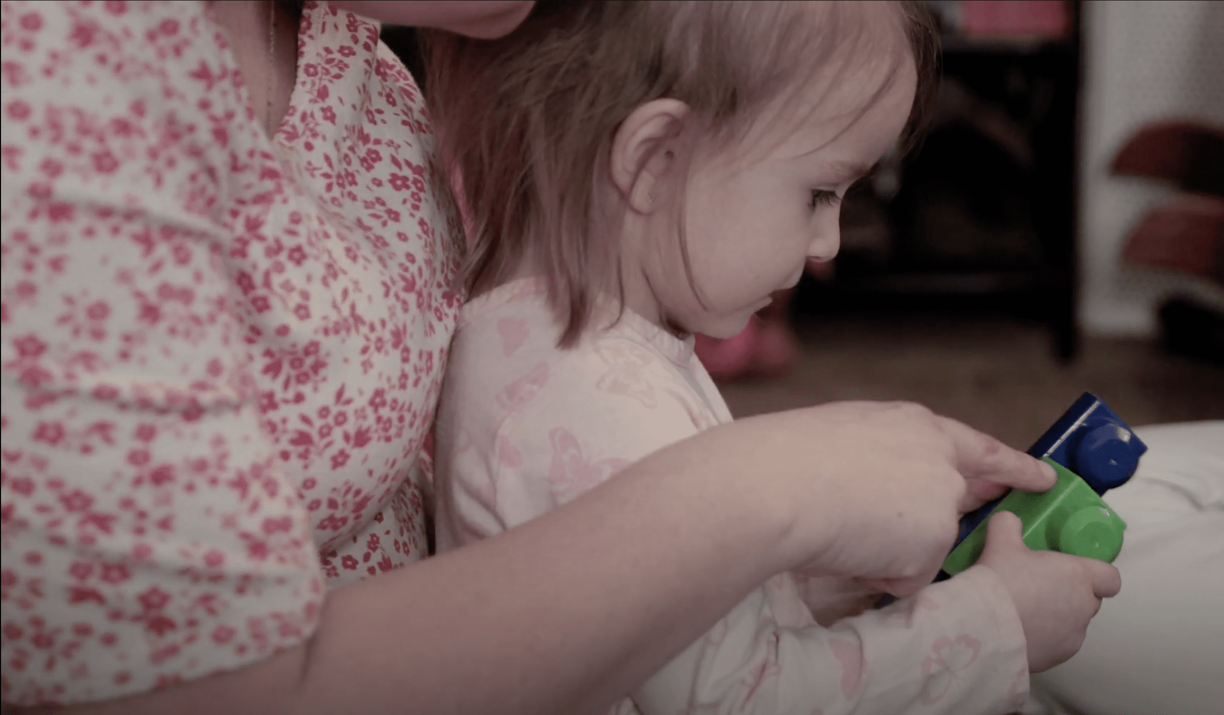 Tia and Winnie playing with blocks provided by Help Me Grow